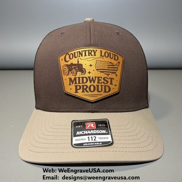 WeEngrave USA brown and tan Richardson 112 trucker hat with a leather patch featuring a tractor, American flag, and "Country Loud Midwest Proud" text.