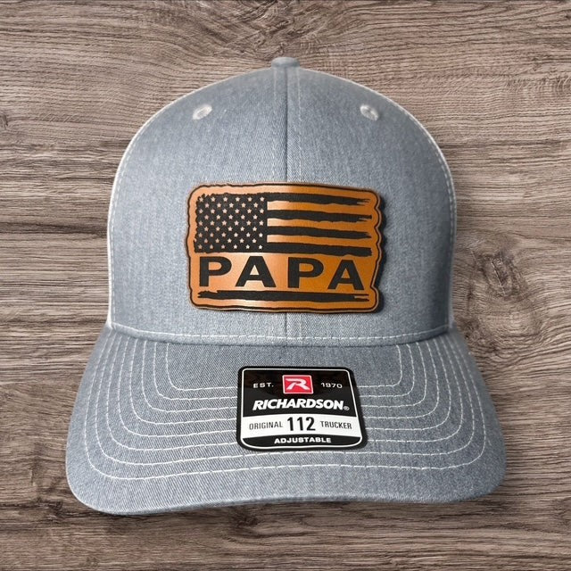 WeEngrave USA light blue trucker hat with "PAPA" and American flag engraved leatherette patch. Richardson 112 style.